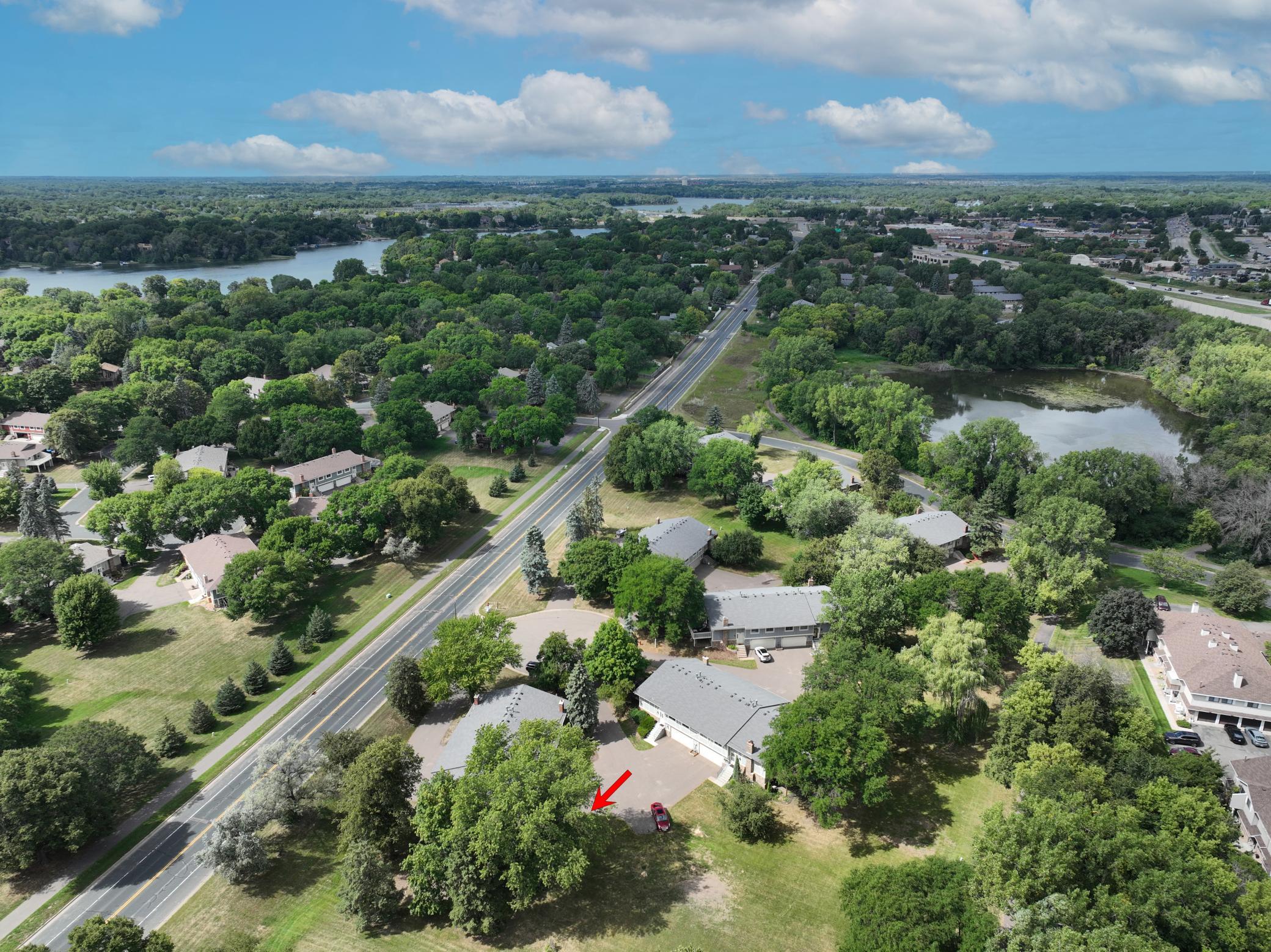 Wide aerial view showcasing the property and the surrounding residential landscape.