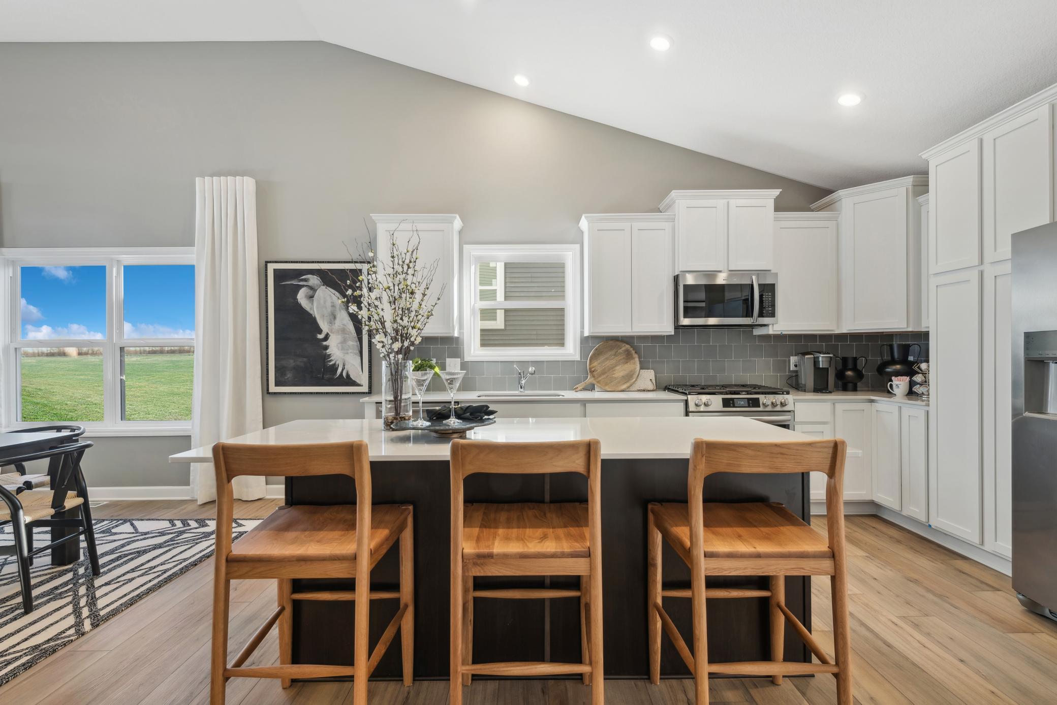 (Photo of a decorated model, actual homes finishes will vary) This home has so much to offer! The open floor plan & high vaulted ceilings provide a very custom home feel.