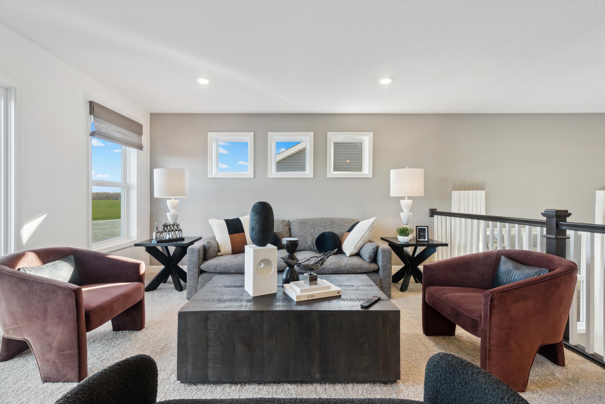 (Photo of a decorated model, actual homes finishes will vary) Access the upper level with a short staircase-you will find a wonderful family room, 3 bedrooms (including the owner suite), and a hall bath.