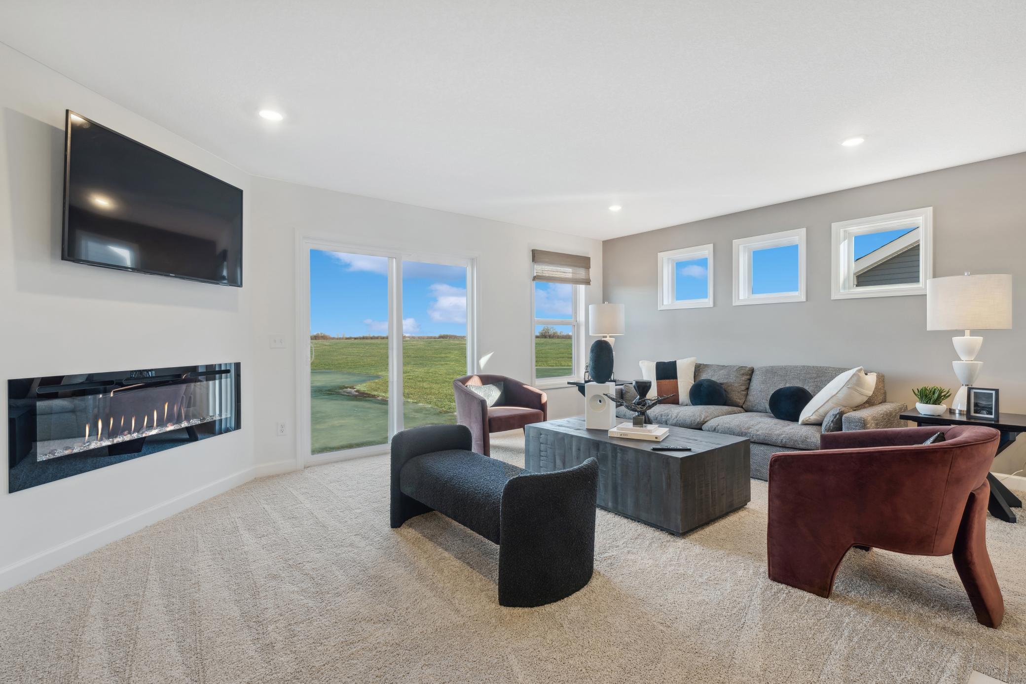 (Photo of a decorated model, actual homes finishes will vary) Light-filled great room that is located on the same upper floor as the bedrooms - a complete custom feel.