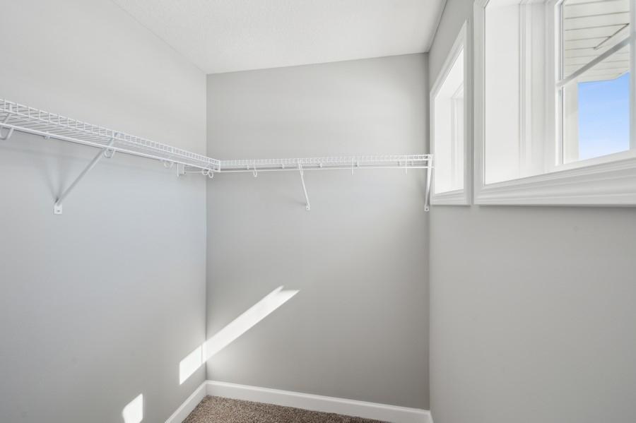 (Photo of a decorated model, actual homes finishes will vary) The primary bedroom features an incredible walk-in closet.