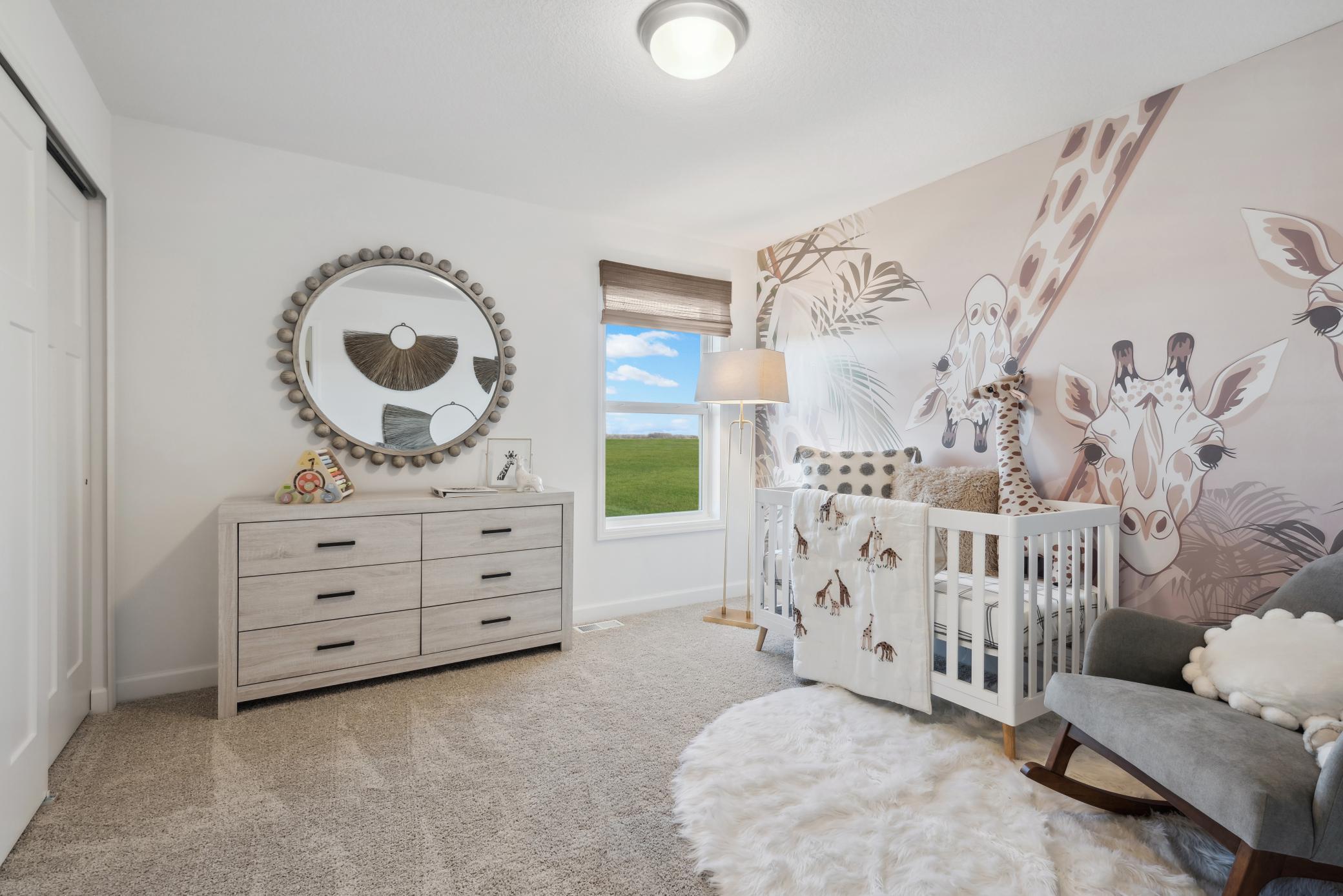 (Photo of a decorated model, actual homes finishes will vary) One of the spacious secondary bedrooms on the upper level.