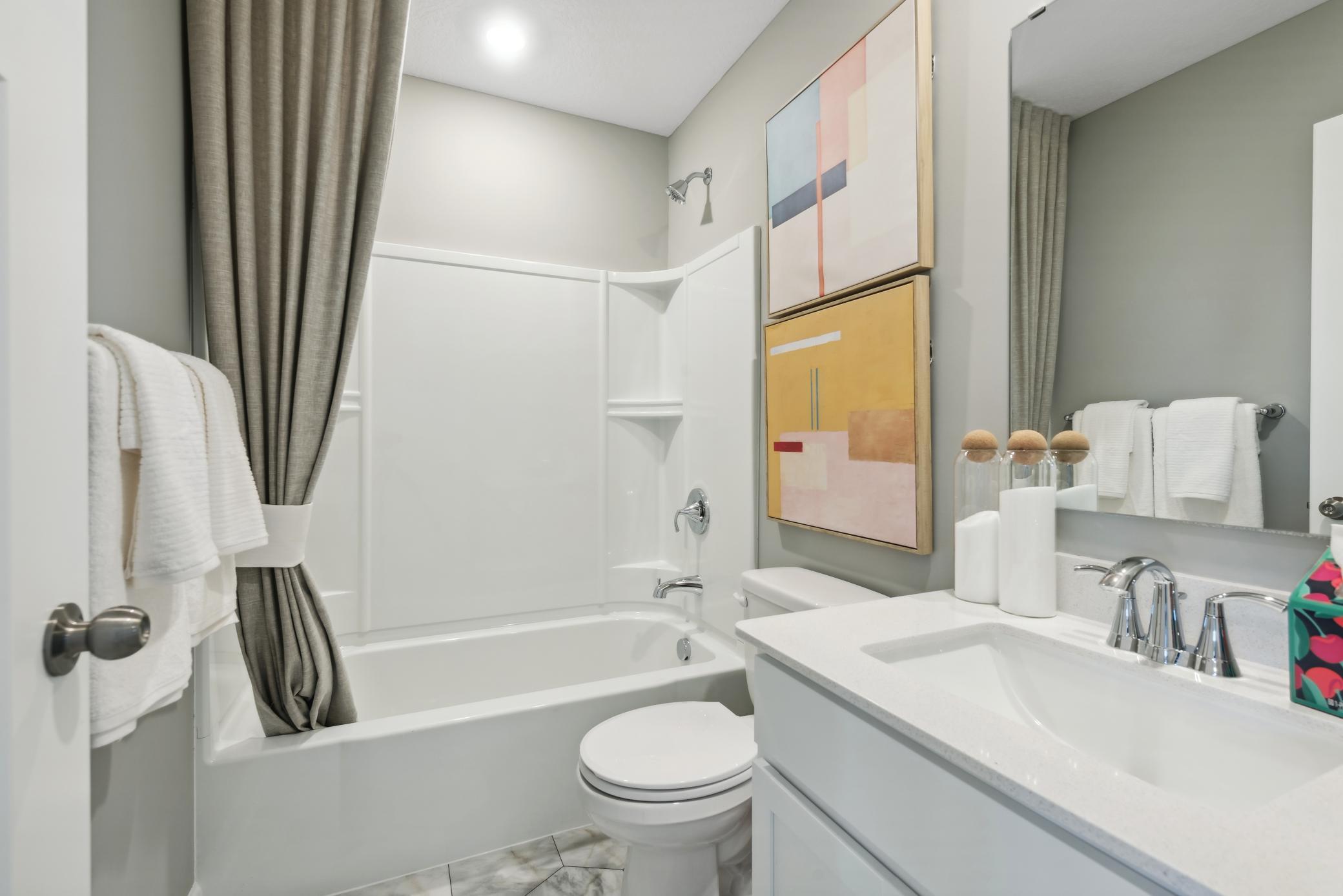(Photo of a decorated model, actual homes finishes will vary) There is a full hall bath that is conveniently located by bedrooms 2 and 3 on the upper level.
