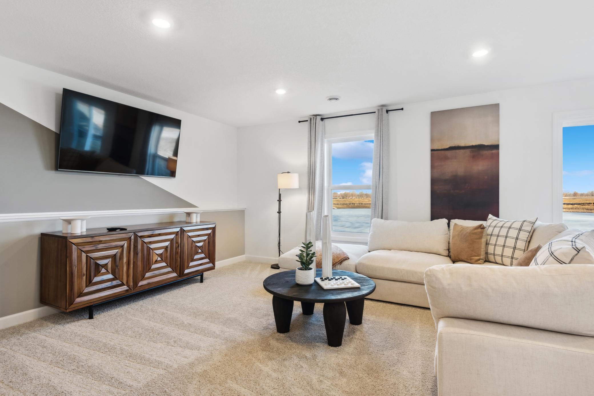 (Photo of a decorated model, actual homes finishes will vary) Another view of the recreation room.