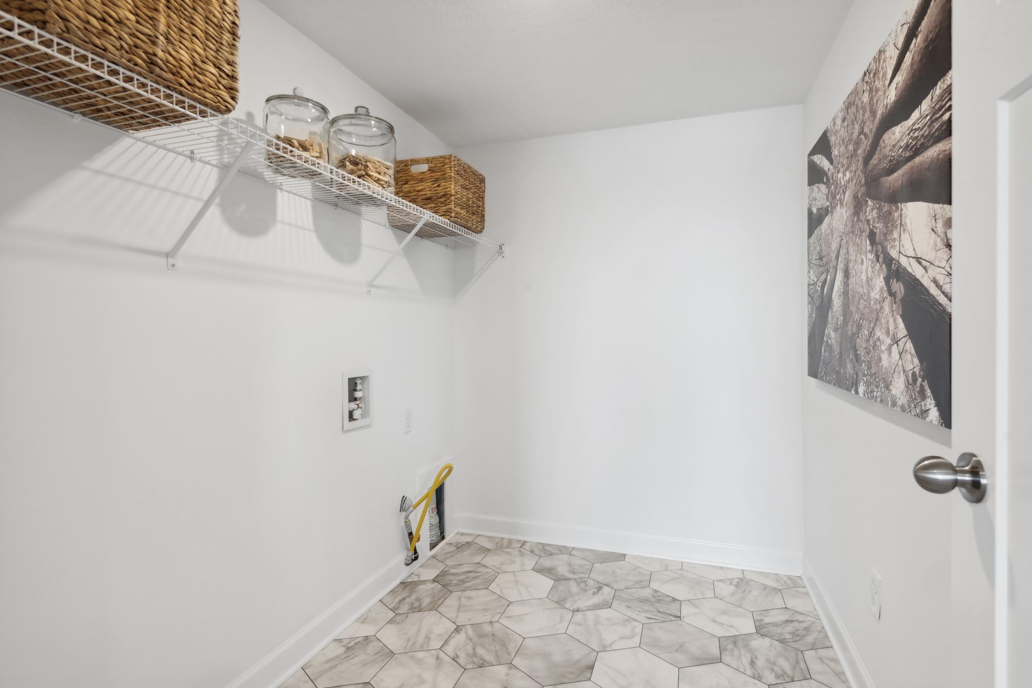 (Photo of a decorated model, actual homes finishes will vary) Convenient lower-level laundry!