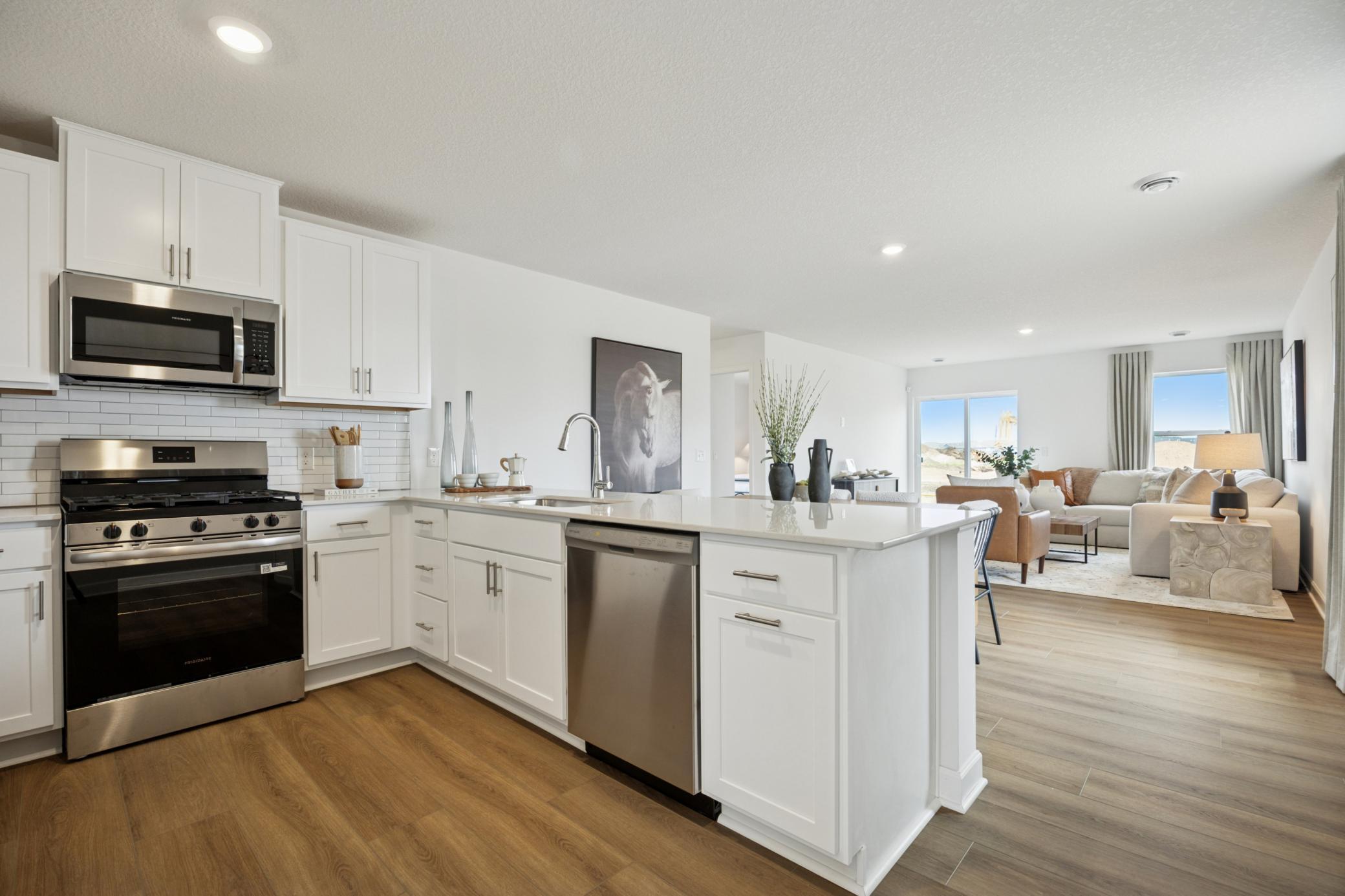 (Photo of a decorated model. Features and finishes will vary.) The open concept layout in the kitchen, dining room, and Great Room make entertaining a dream!