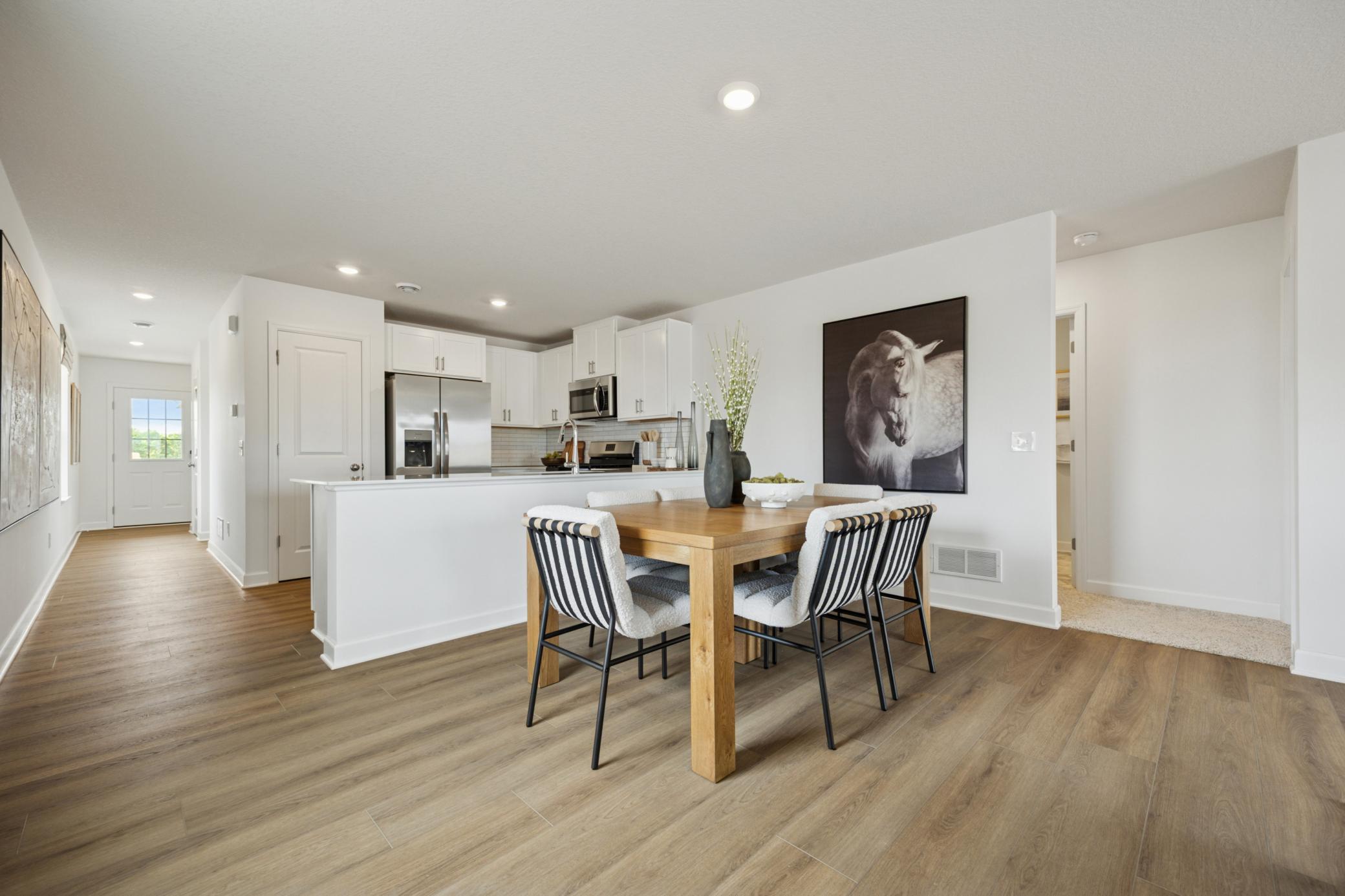 (Photo of a decorated model. Features and finishes will vary.) A view of the informal dining room and kitchen.