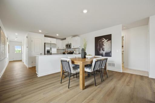 (Photo of a decorated model. Features and finishes will vary.) A view of the informal dining room and kitchen.