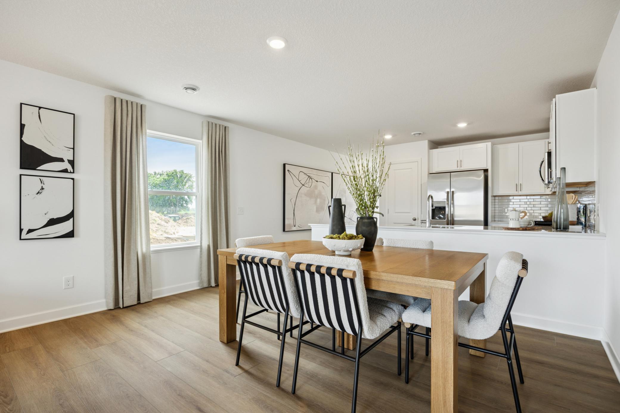 (Photo of a decorated model. Features and finishes will vary.) Another view of the dining room and kitchen.