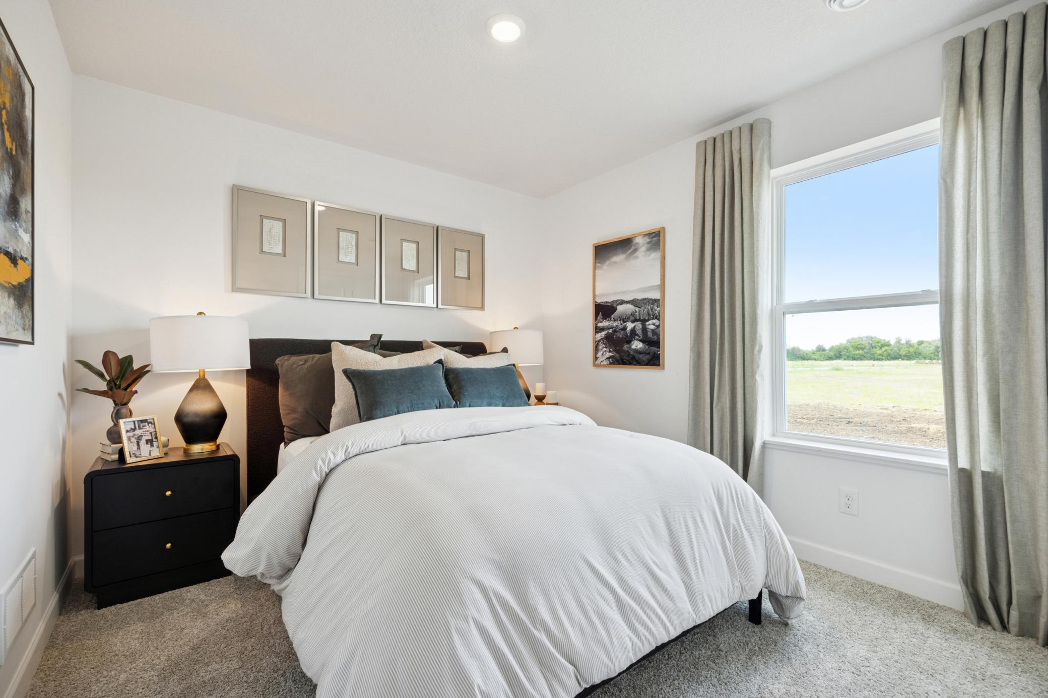 (Photo of a decorated model. Features and finishes will vary.) One of the spacious secondary bedrooms!