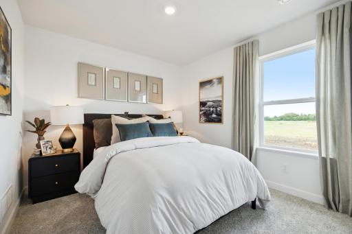 (Photo of a decorated model. Features and finishes will vary.) One of the spacious secondary bedrooms!