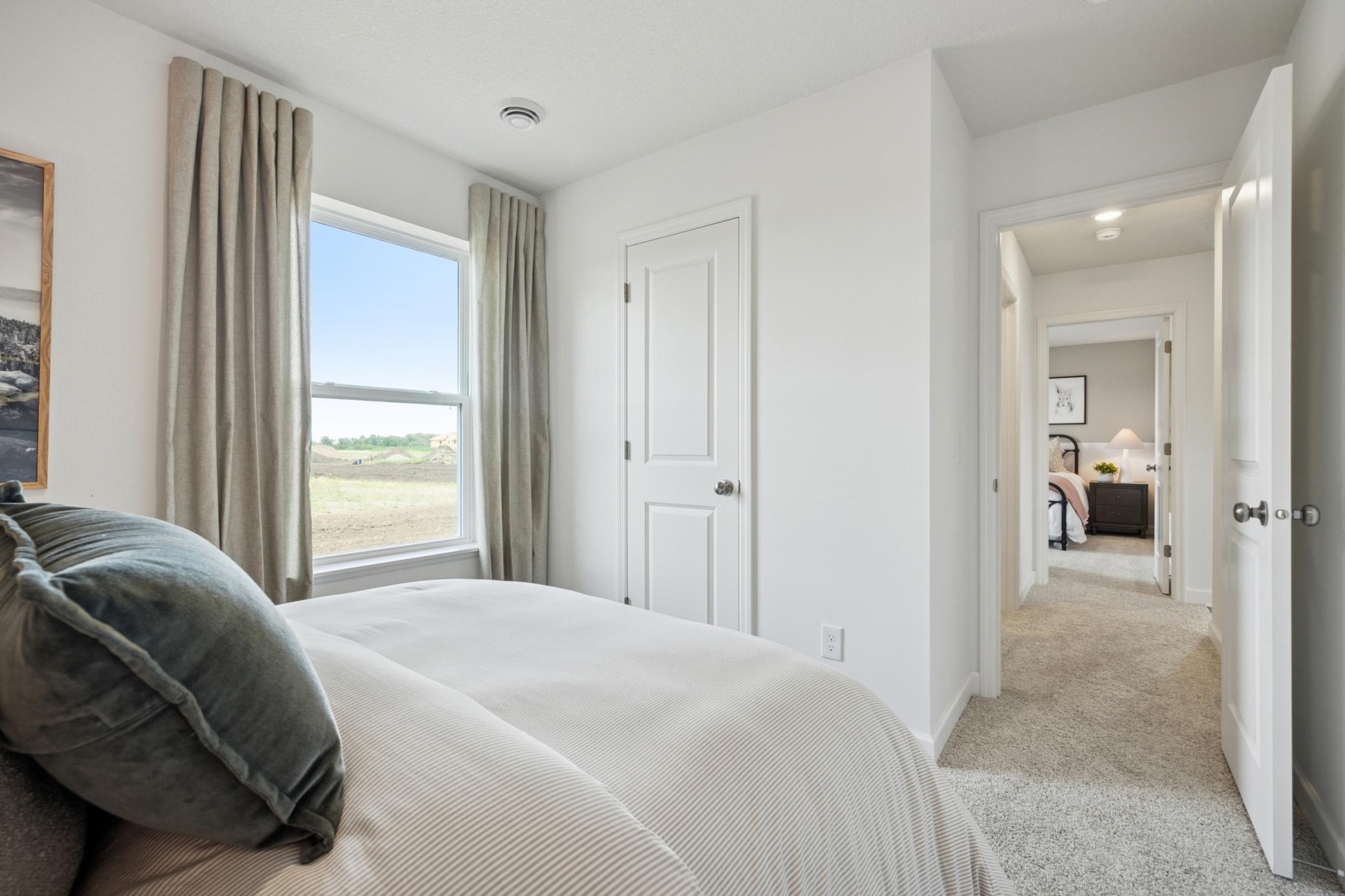 (Photo of a decorated model. Features and finishes will vary.) One of the spacious secondary bedrooms!
