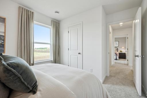 (Photo of a decorated model. Features and finishes will vary.) One of the spacious secondary bedrooms!