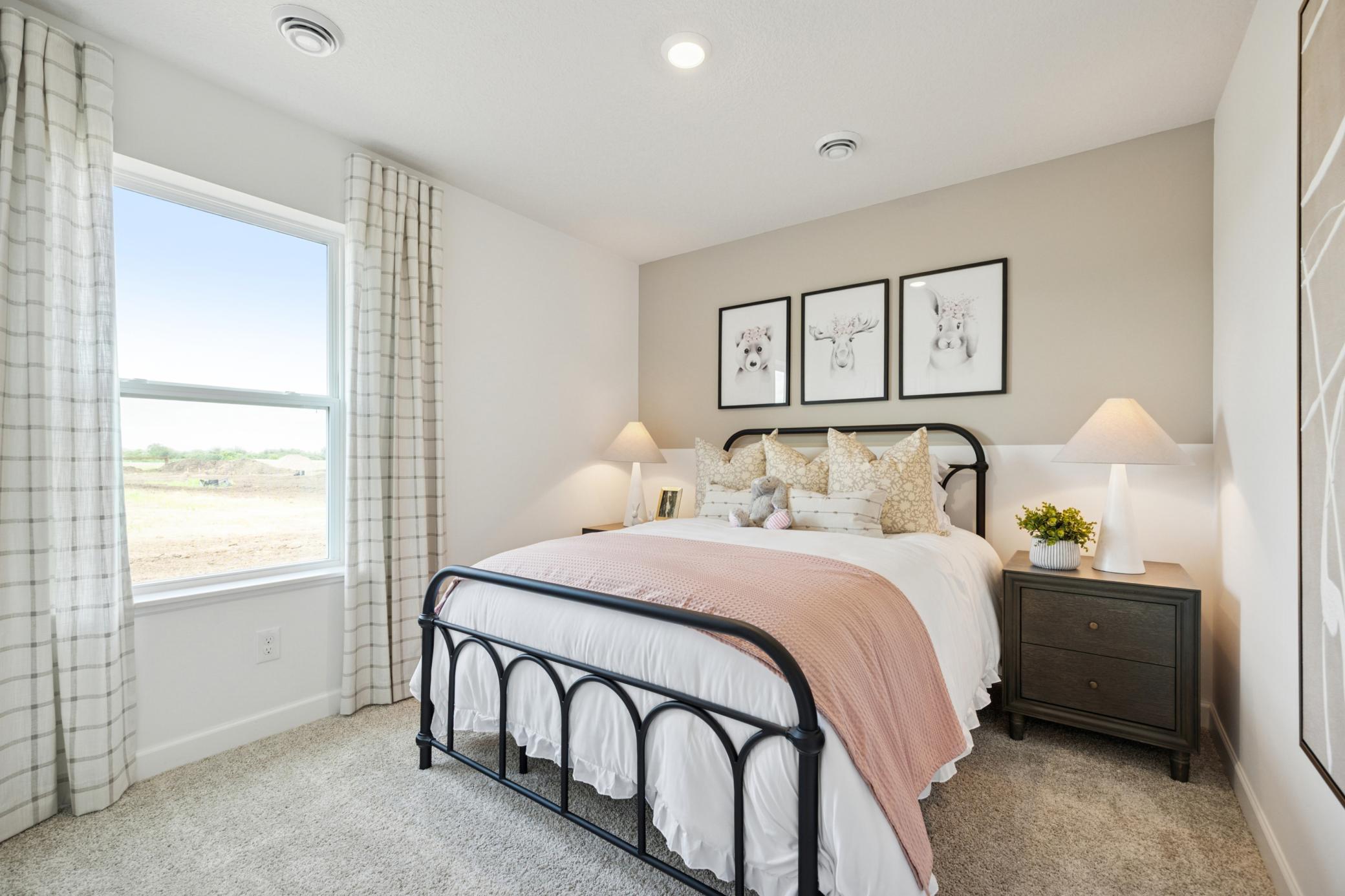 (Photo of a decorated model. Features and finishes will vary.) One of the spacious secondary bedrooms!