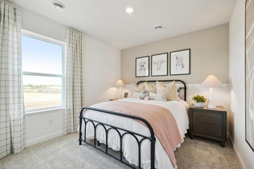 (Photo of a decorated model. Features and finishes will vary.) One of the spacious secondary bedrooms!