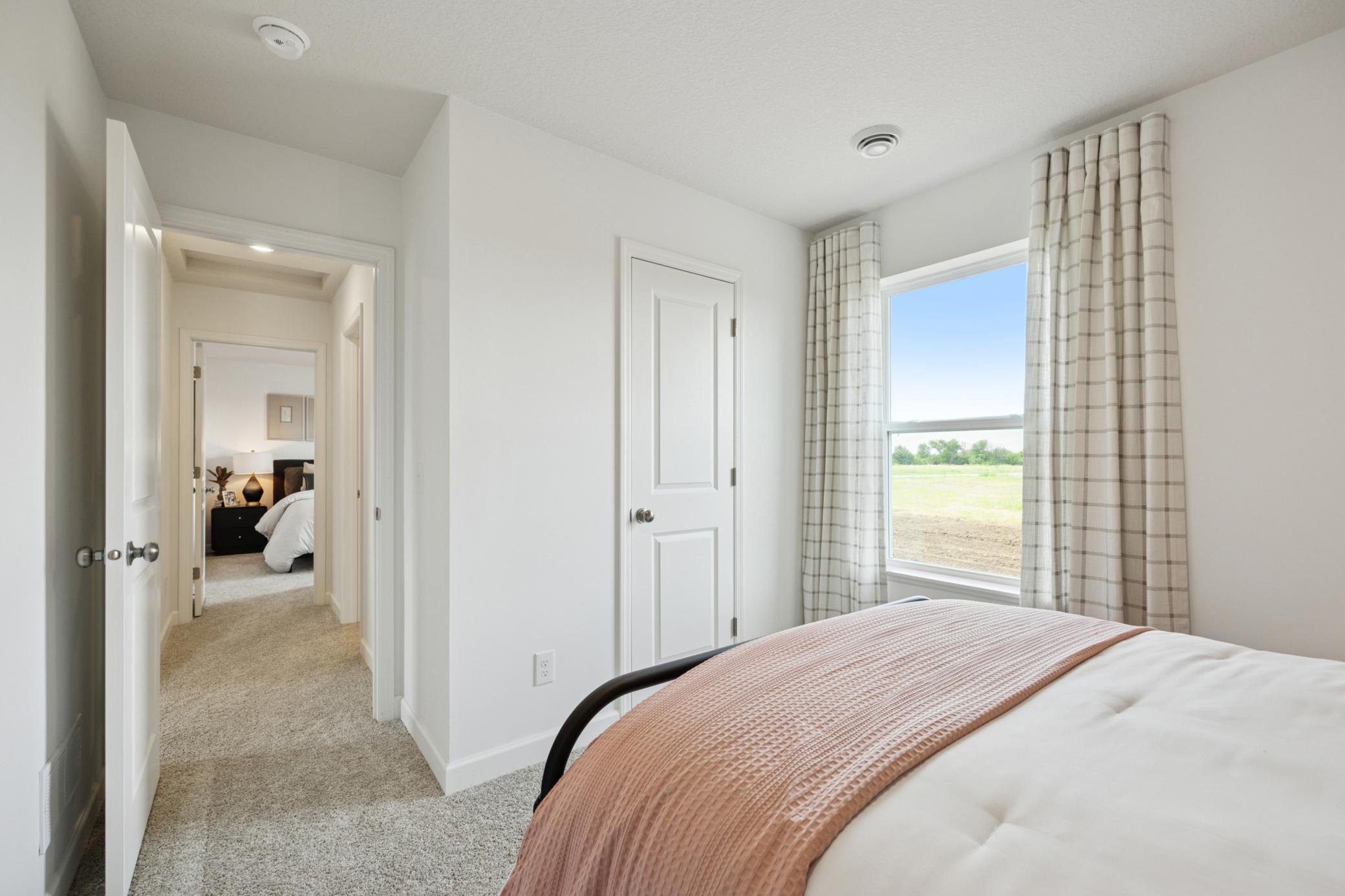 (Photo of a decorated model. Features and finishes will vary.) One of the spacious secondary bedrooms!