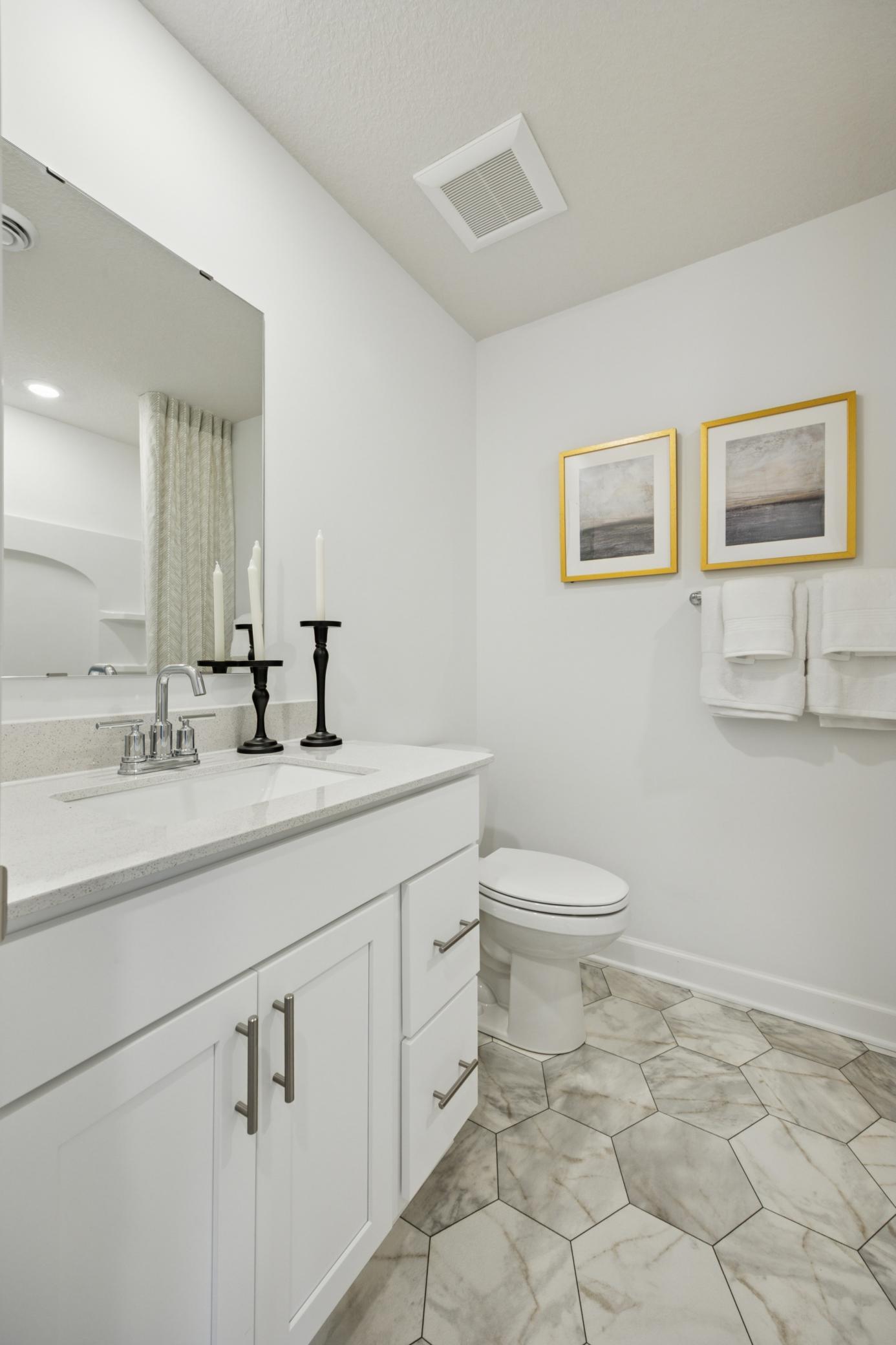 (Photo of a decorated model. Features and finishes will vary.) The full secondary bath!