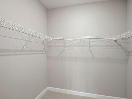 A mesh shelf in the walk-in closet provides wardrobe organization