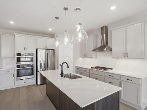 The kitchen features brand-new appliances, ample cabinetry, designer-selected countertops and a pantry for added storage space.