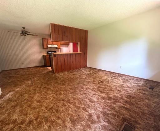 Open concept with living room, dining area & kitchen with breakfast bar