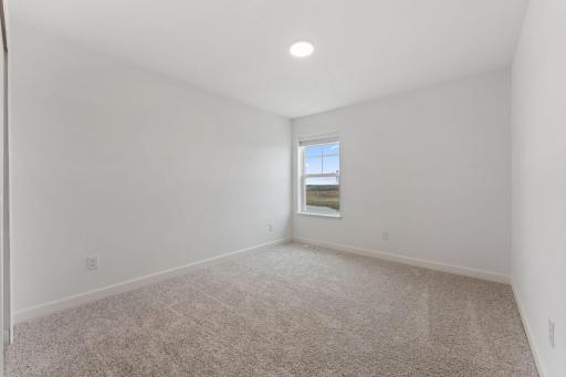 (Photo of a similar home, actual finishes may vary) The two secondary bedrooms can be found on the top level to provide a quiet haven away from the bustling downstairs main living area.