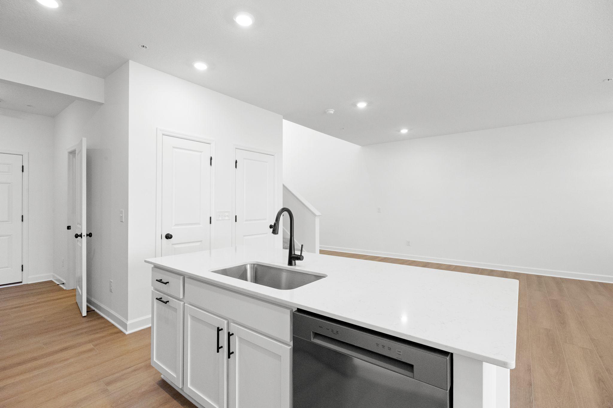 This center island includes a stainless steel sink with designer faucet to remove stubborn stains