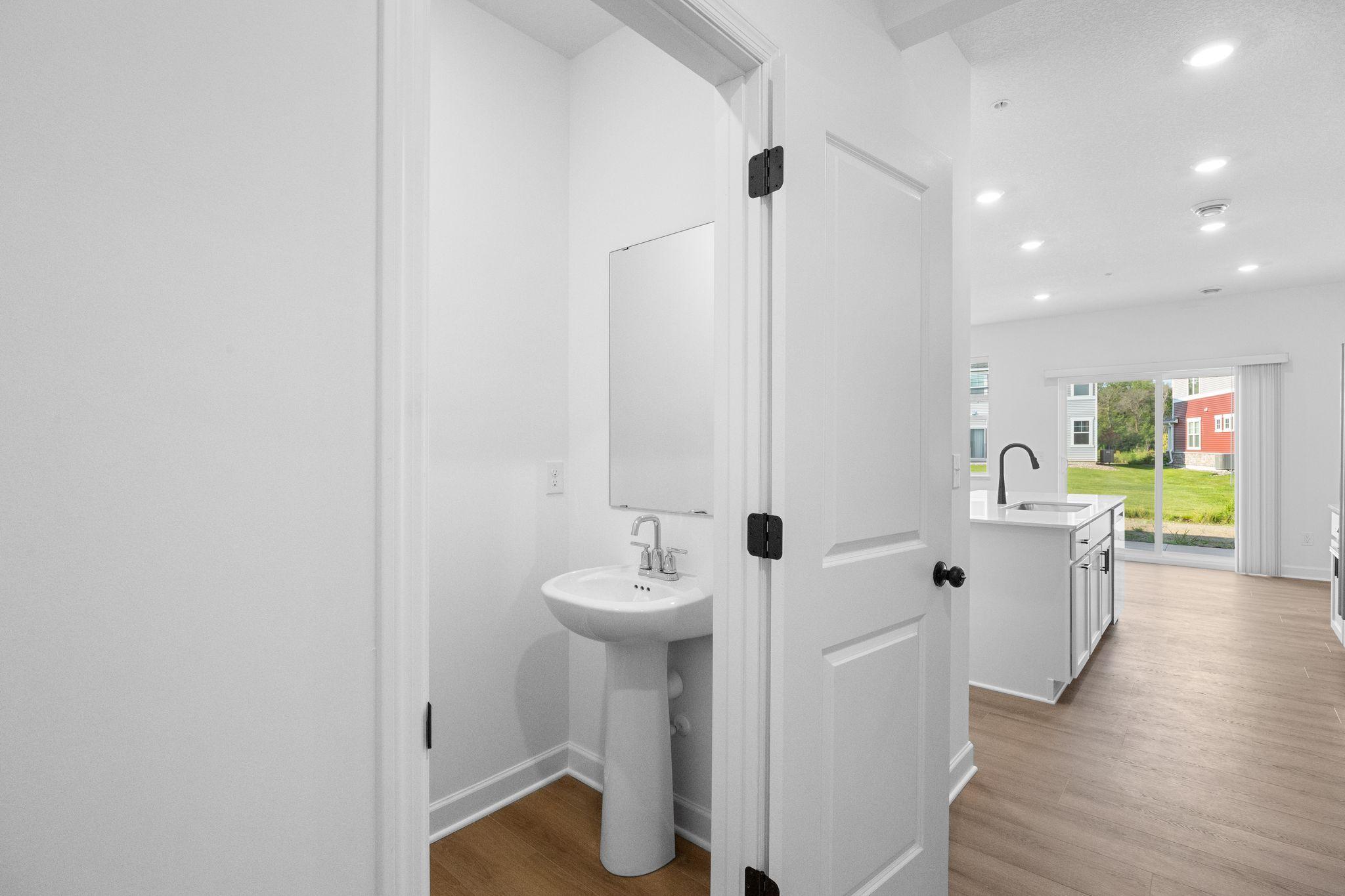 Situated directly off the kitchen, this powder room optimizes the first-floor main living area for residents and guests alike.