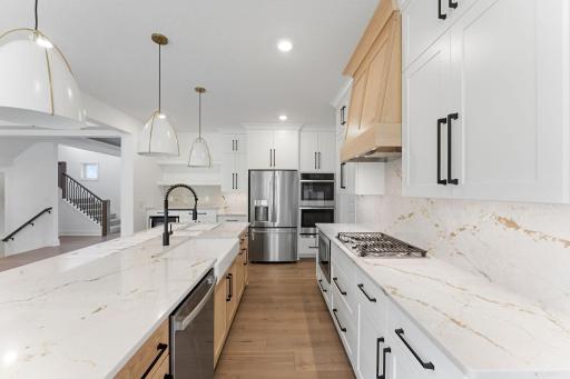 A large pantry with built-in shelving provides convenient space for snacks, dry goods and other culinary essentials