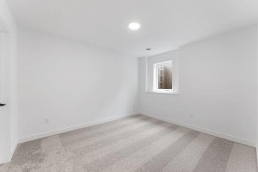 A bedroom on the lower level offers enhanced privacy and comfort, perfect for older children or guests.
