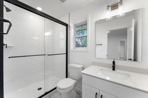 The attached bathroom boasts a stylish vanity with a sink and sleek cabinetry
