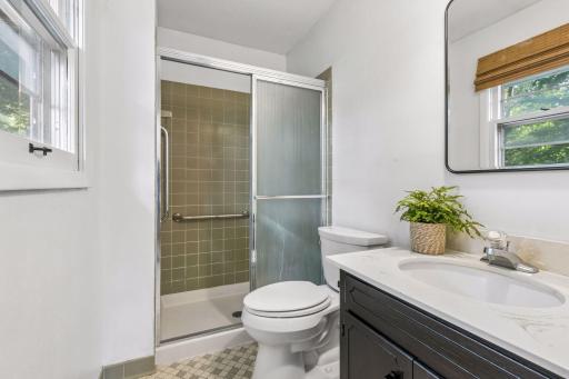 Primary bedroom's 3/4 bath with contemporary tile color