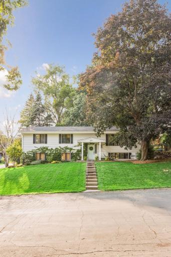 Lovely low maintenance landscaping and tuck under oversized garage on the left.