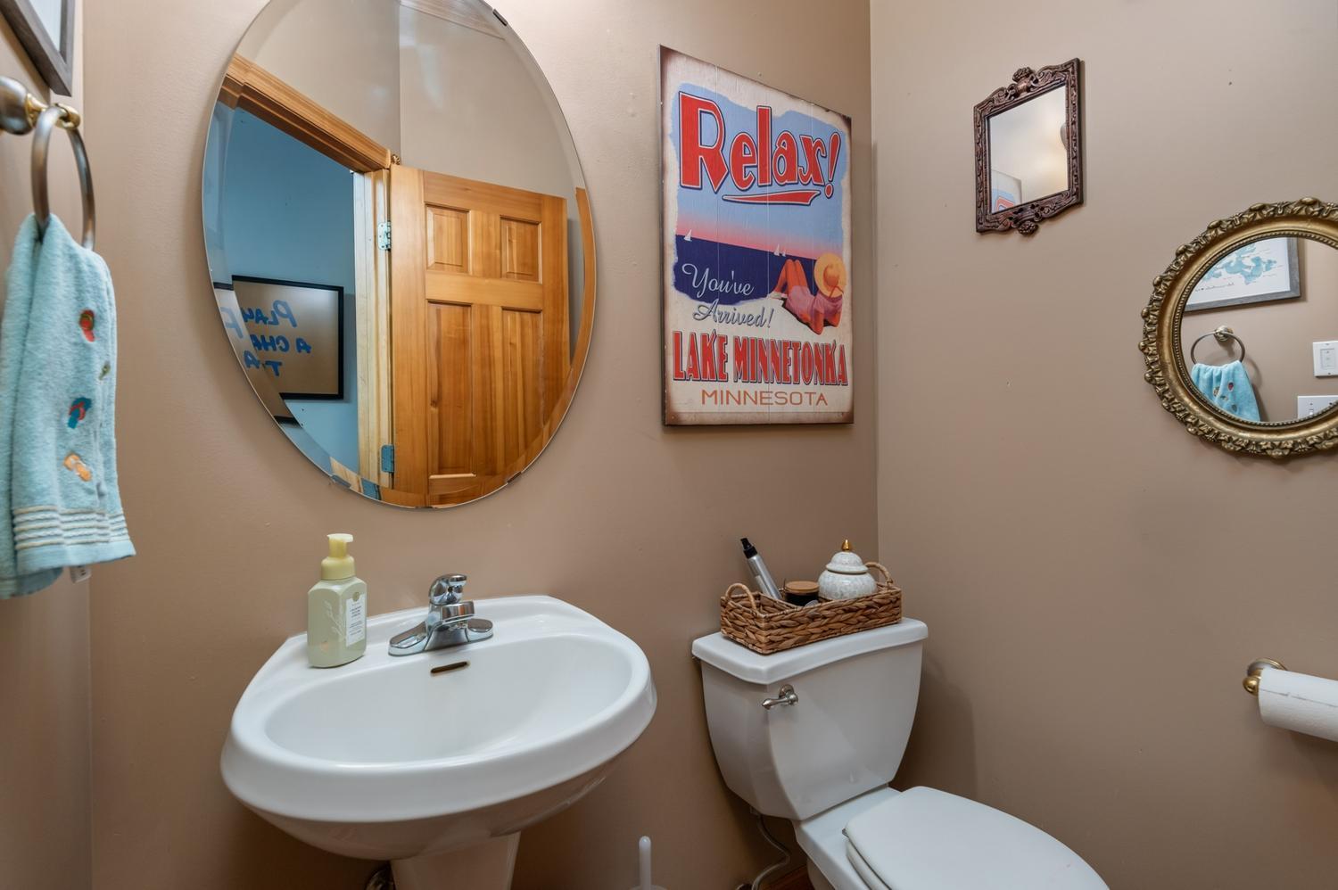 The main floor half bath powder room is tucked away off the mudroom and garage entryway.