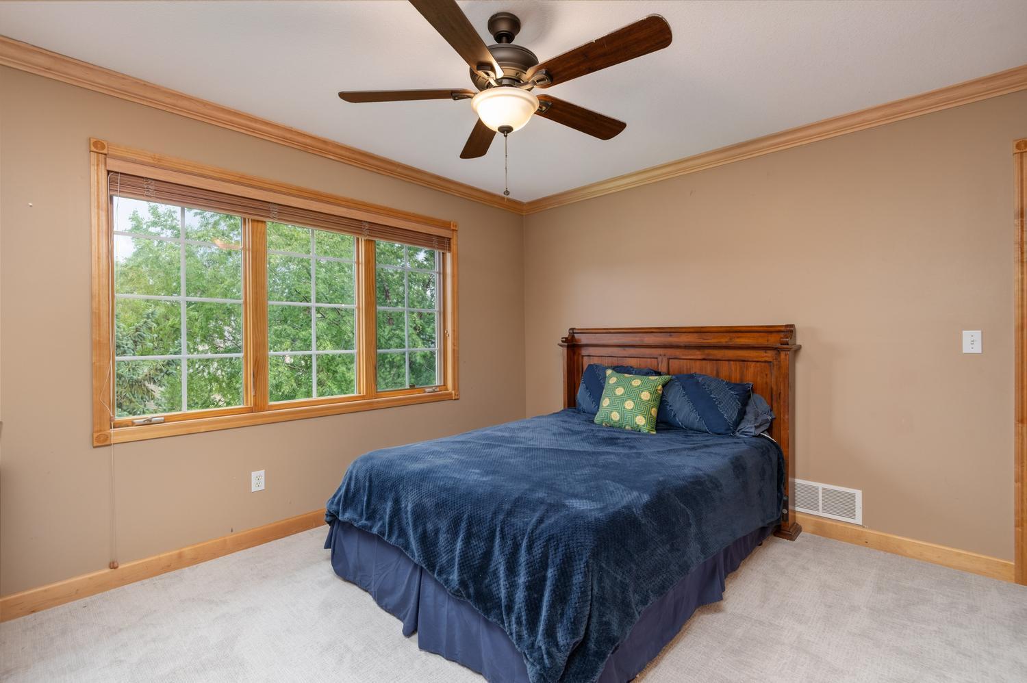 Bedroom 3 has a ceiling fan and looks out to the front yard and culdesac. The life size hockey sticker out of the photo is easily removed.