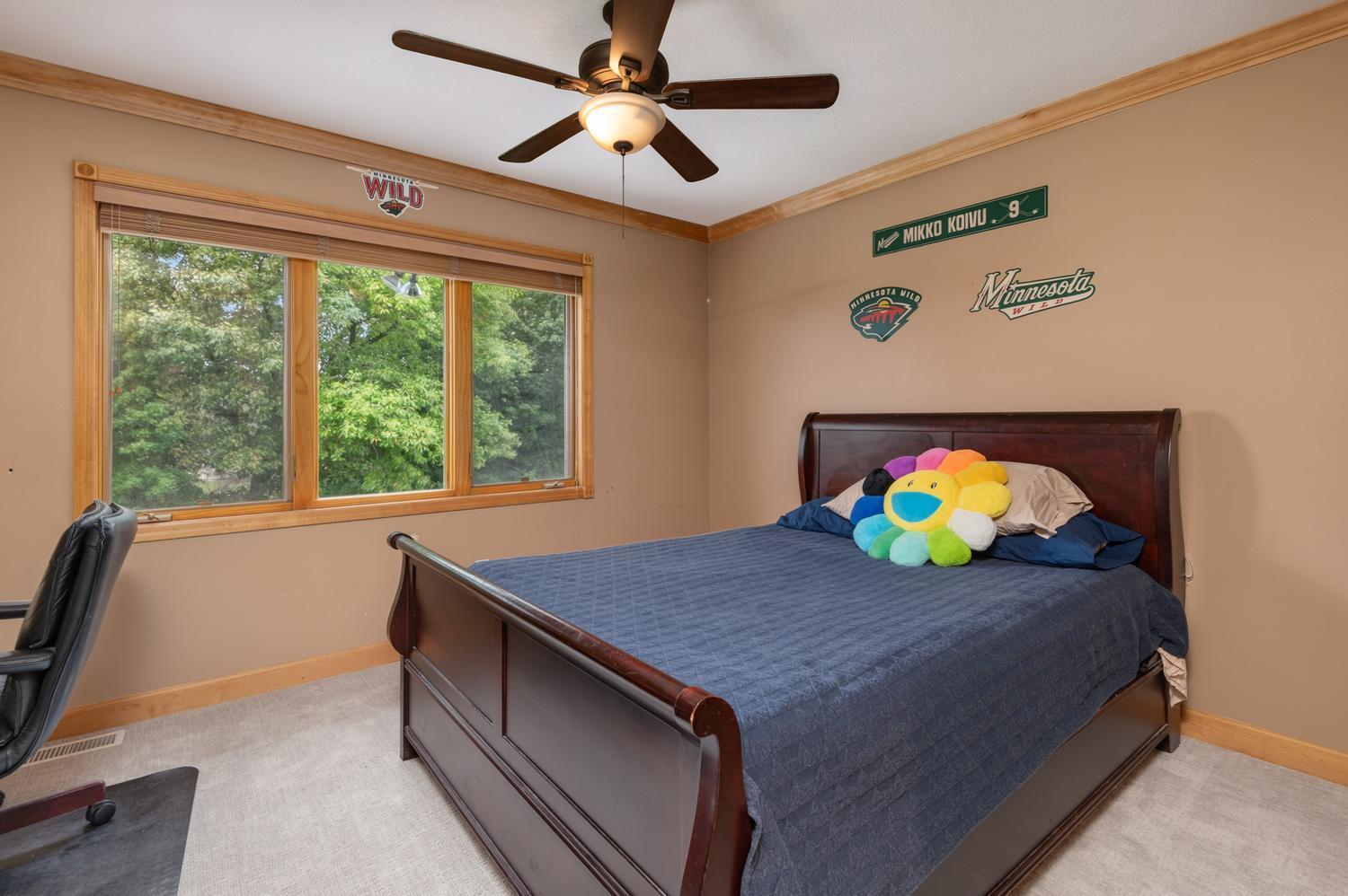 Bedroom 2 looks out to the back yard and lake. It includes the newer plush carpeting and ceiling fan.