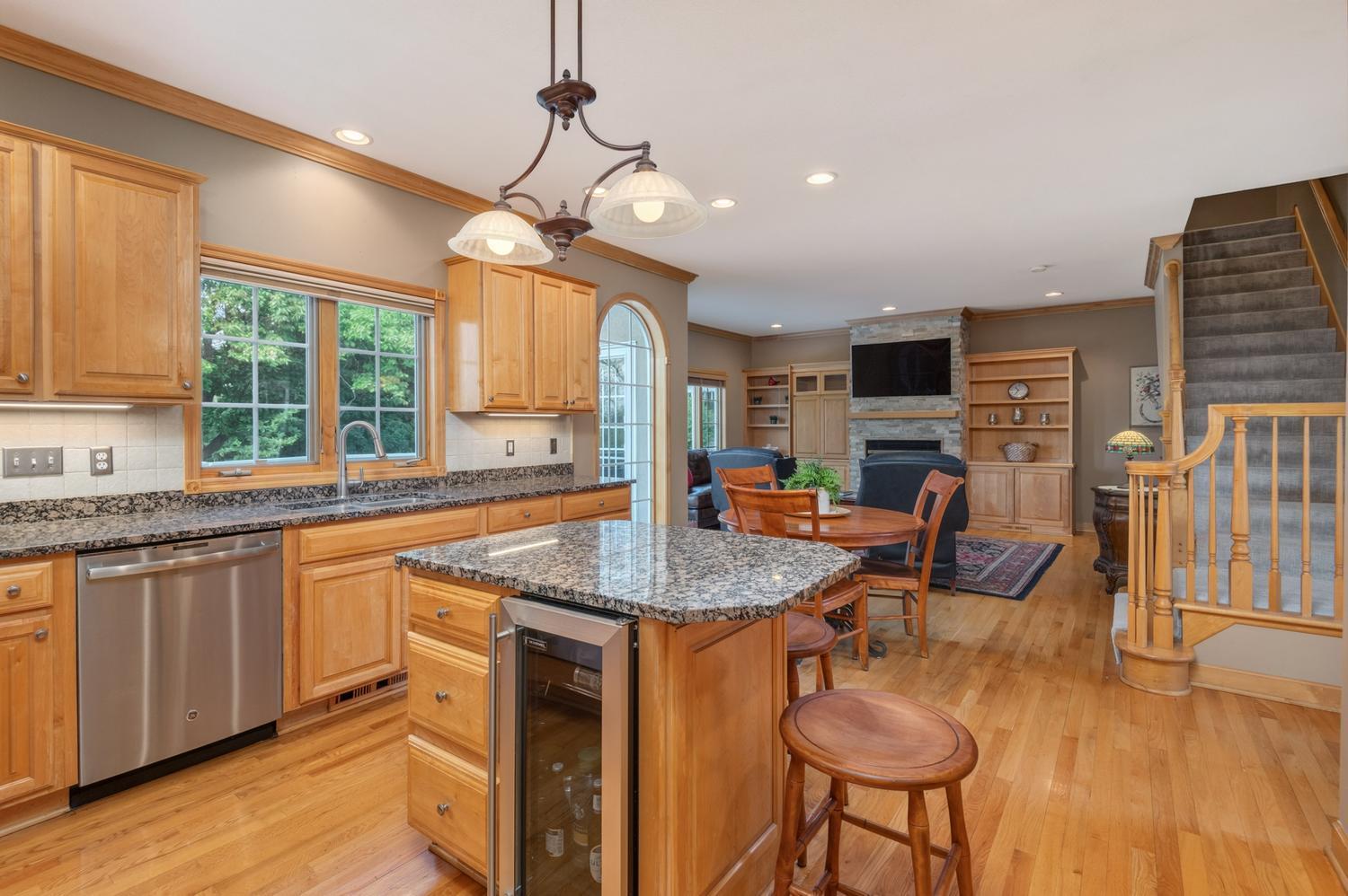 The large kitchen opens to the main floor family room. The wine cooler at the island comes in very handy when you are entertaining family and good friends!