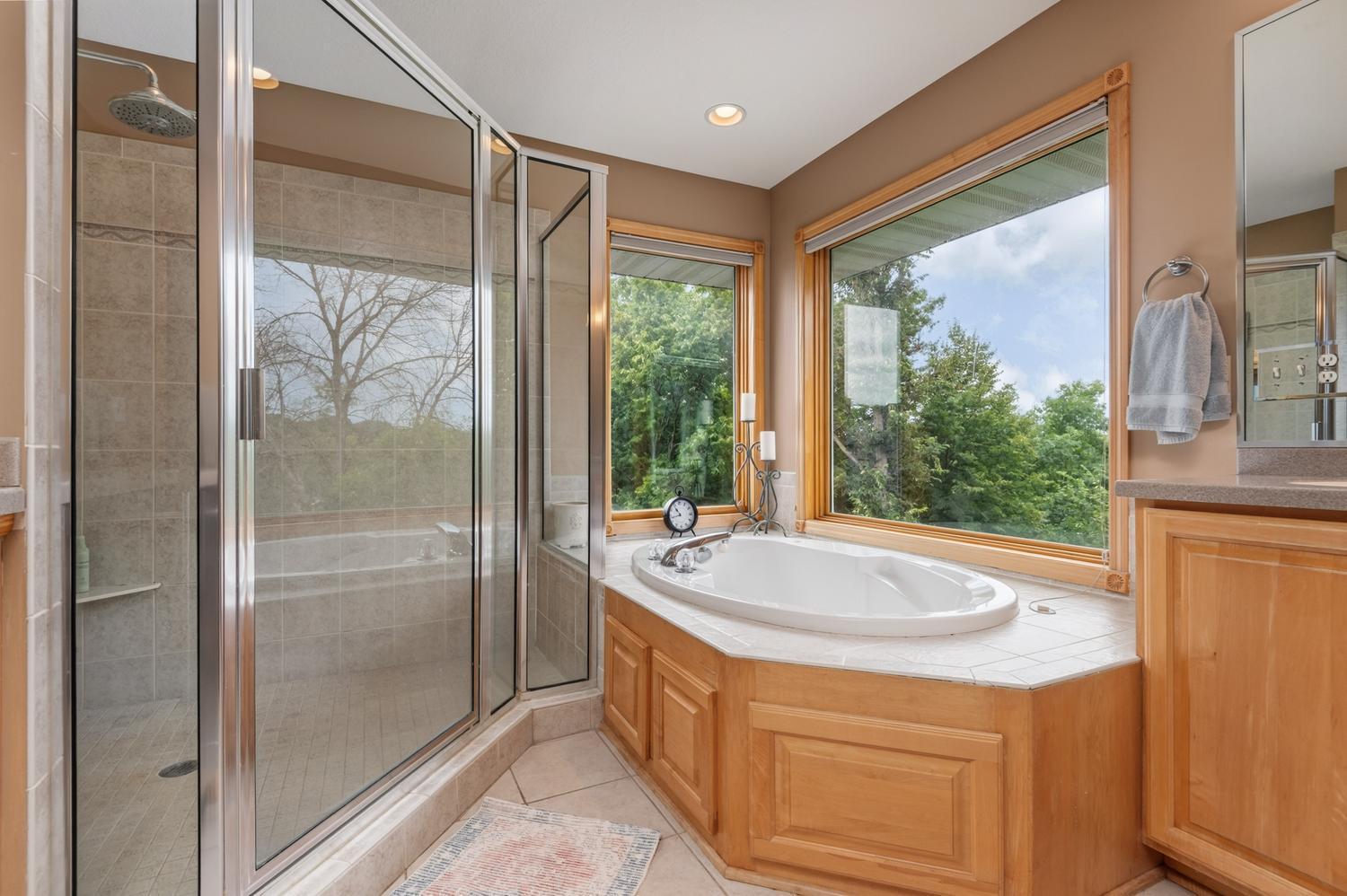 The corner whirlpool bath and very roomy ceramic tile shower look out toward the lake. And you will appreciate two walk in closets!