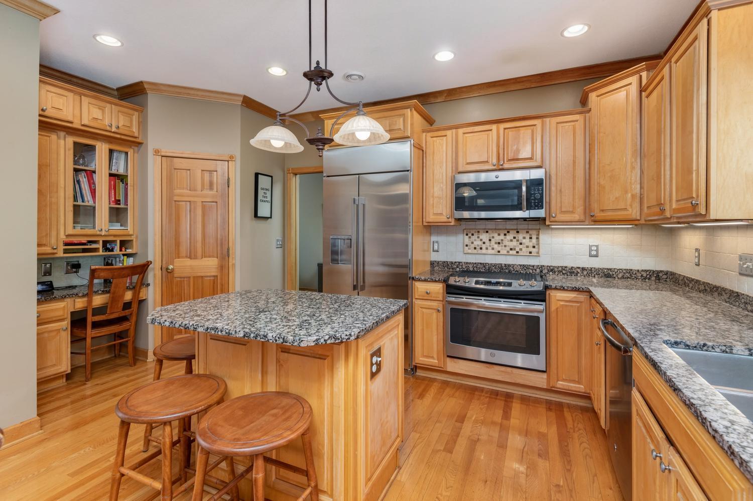 There is also a step in pantry and very handy planning desk with glass front cabinets for all of your cook books.