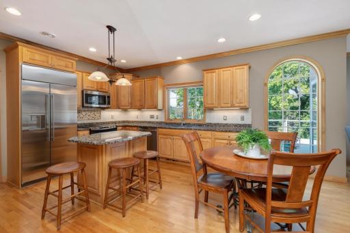 The kitchen offers tons of natural wood cabinetry and granite counter space. Updated GE stainless appliances include a GE Monogram refrigerator.