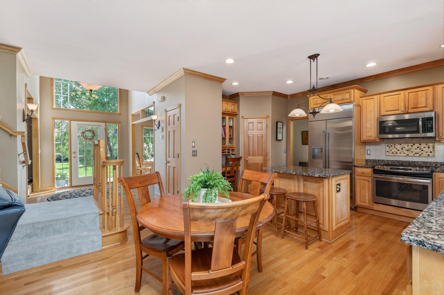 The open floor plan features 9 foot ceilings, recessed lighting, cove molding and hardwood floors throughout most of the main floor.
