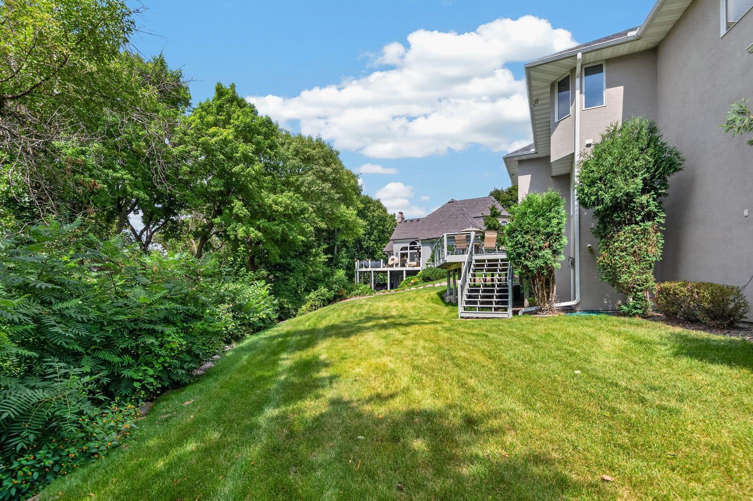 The lot is over a half acre with this back yard plus a large level area down bay the lake. Stairs up to the deck are nice and convenient.