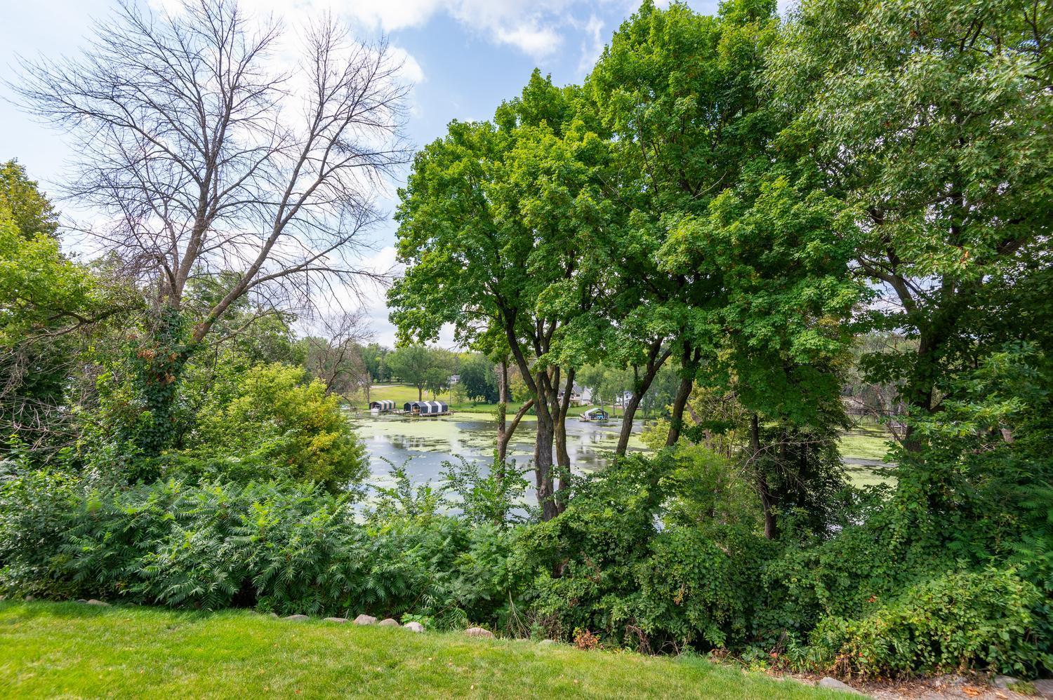 The view from the deck and back yard. There is a trail here that leads down to a large level area at your privately owned lake frontage.