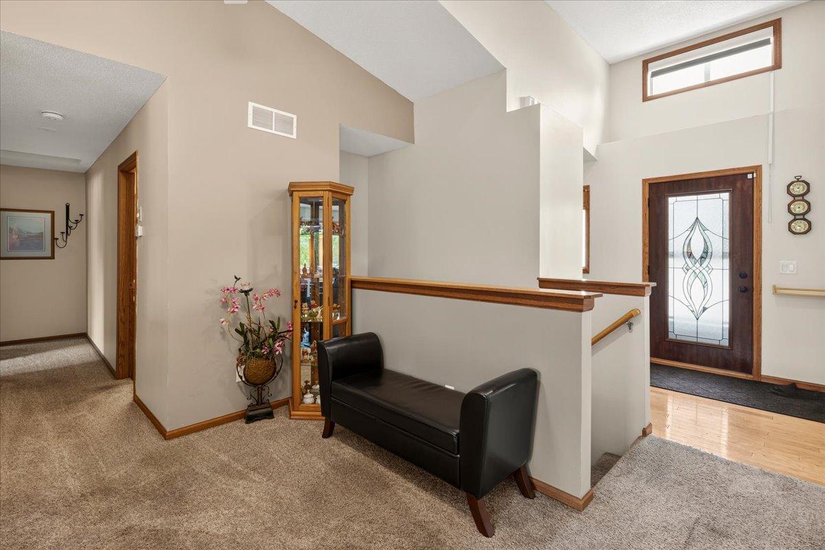 Large entry way has a huge closet as well as this quaint sitting area