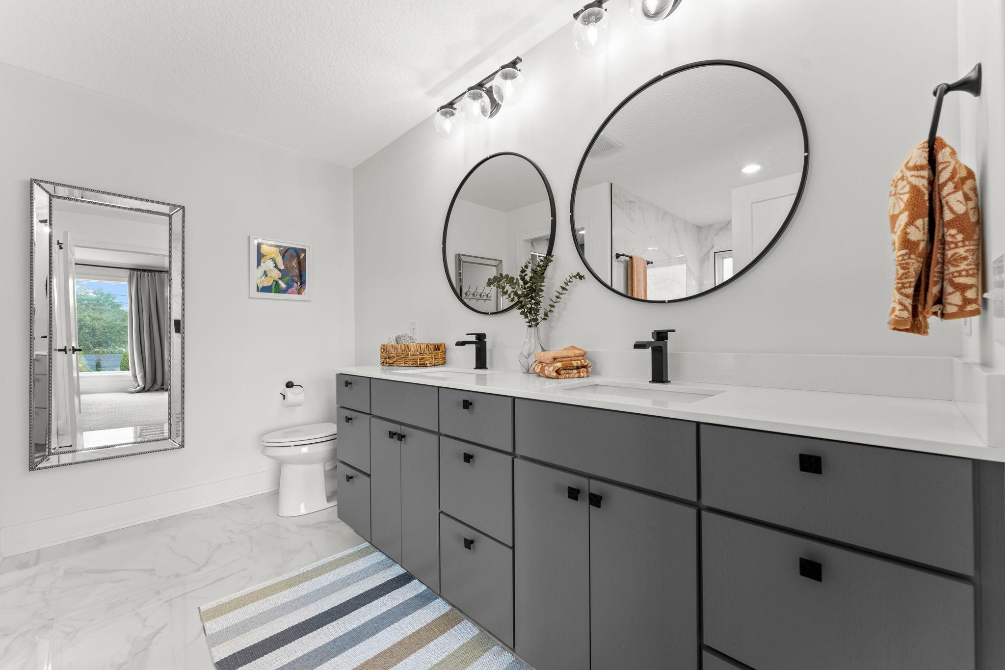 The primary bathroom features a spacious double vanity with abundant storage