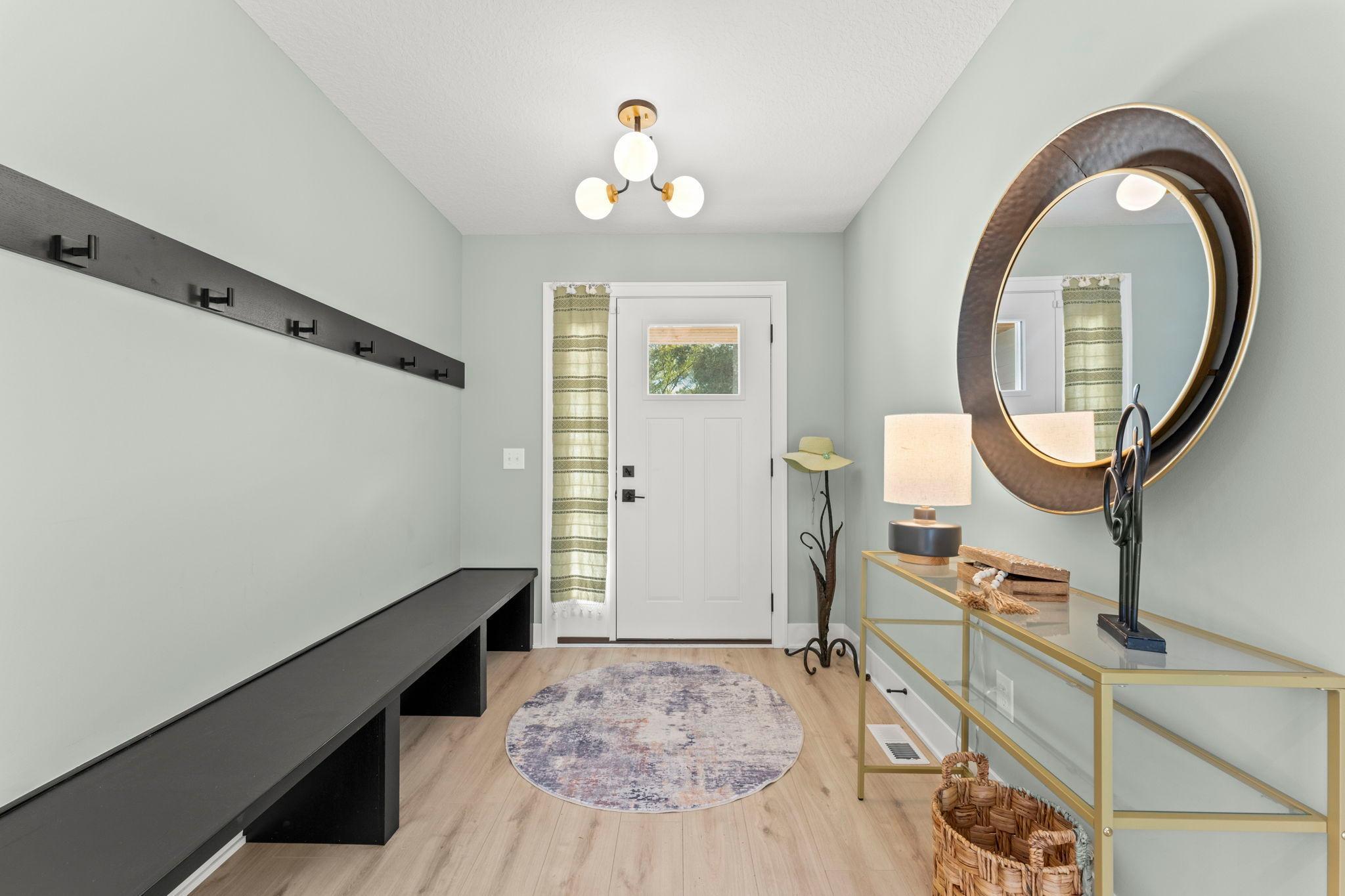 A welcoming foyer with stylish lighting and space for an entry table