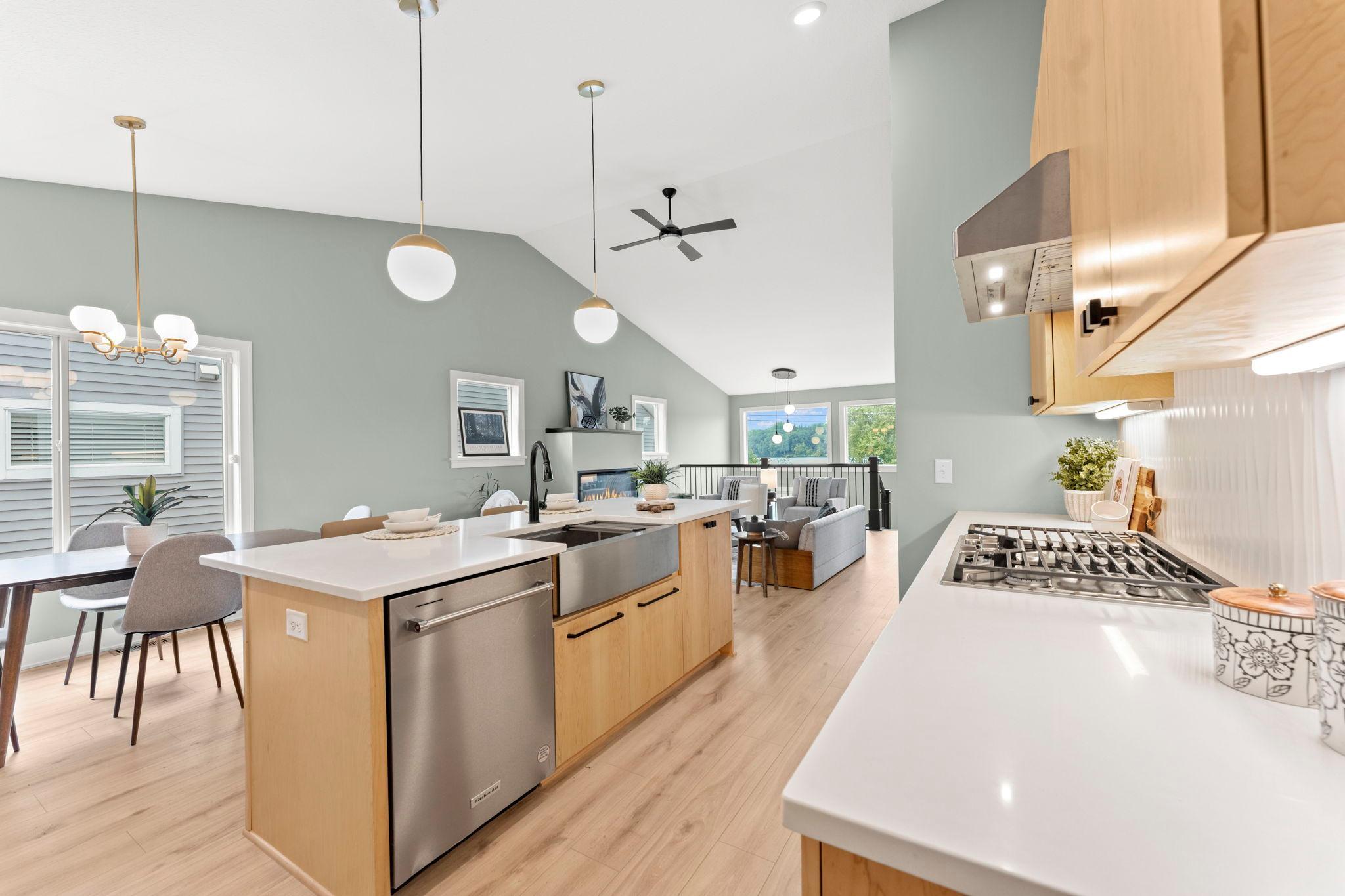 The large kitchen island offers a farmhouse sink, touch activated faucet and space for casual dining