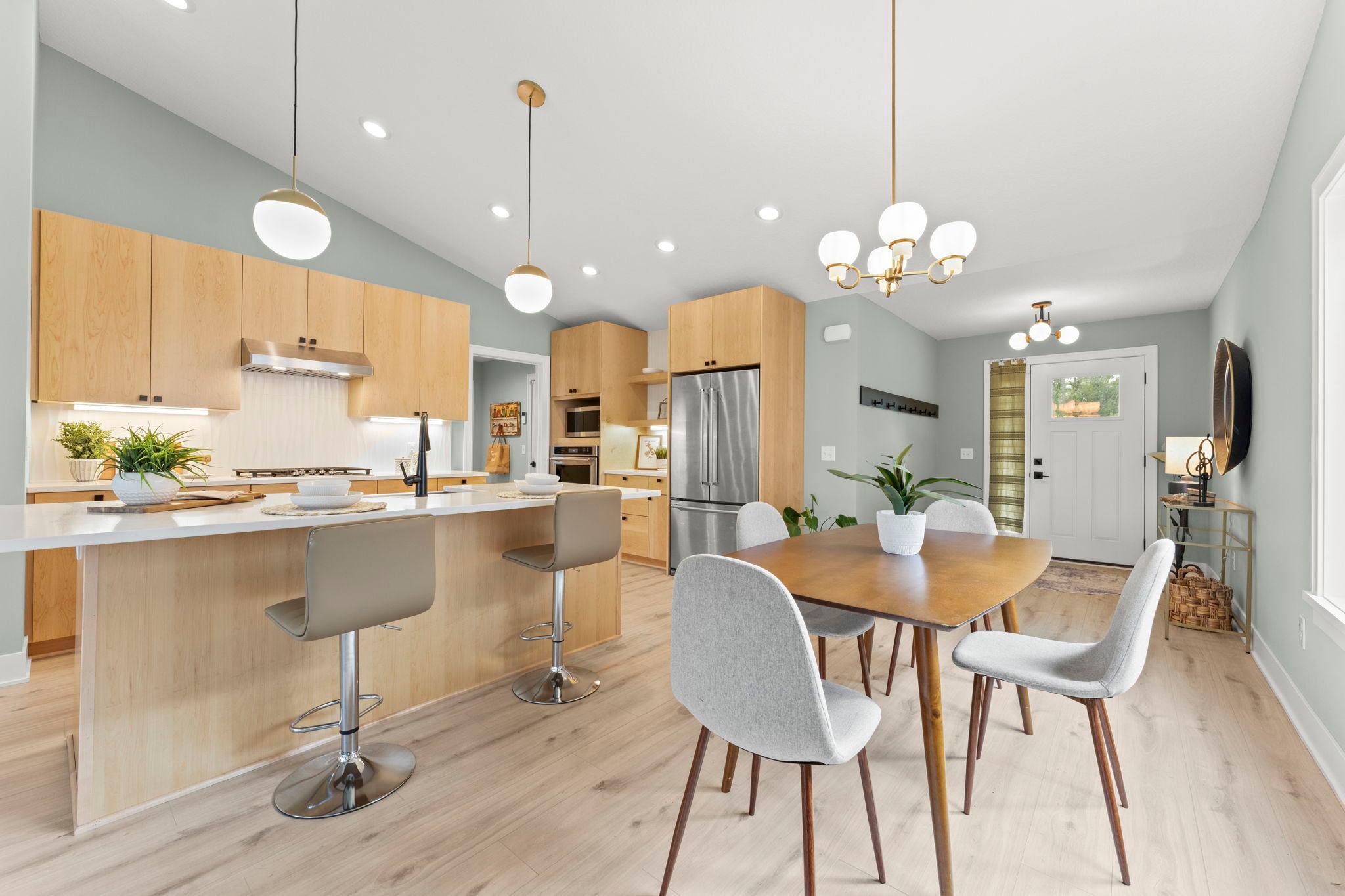 The open kitchen and dining area provide a comfortable setting for everyday meals and entertaining