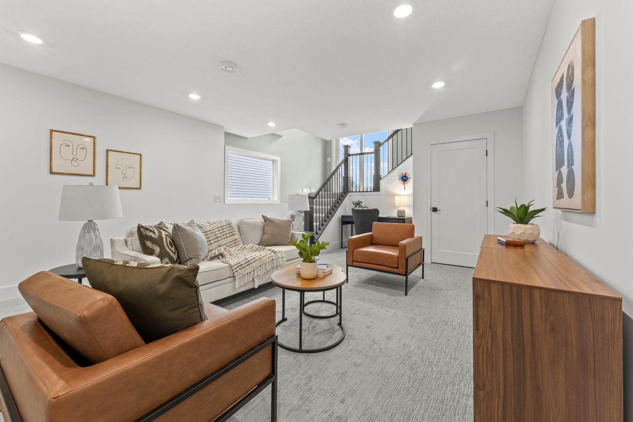 Another view of the beautifully finished lower level and open staircase