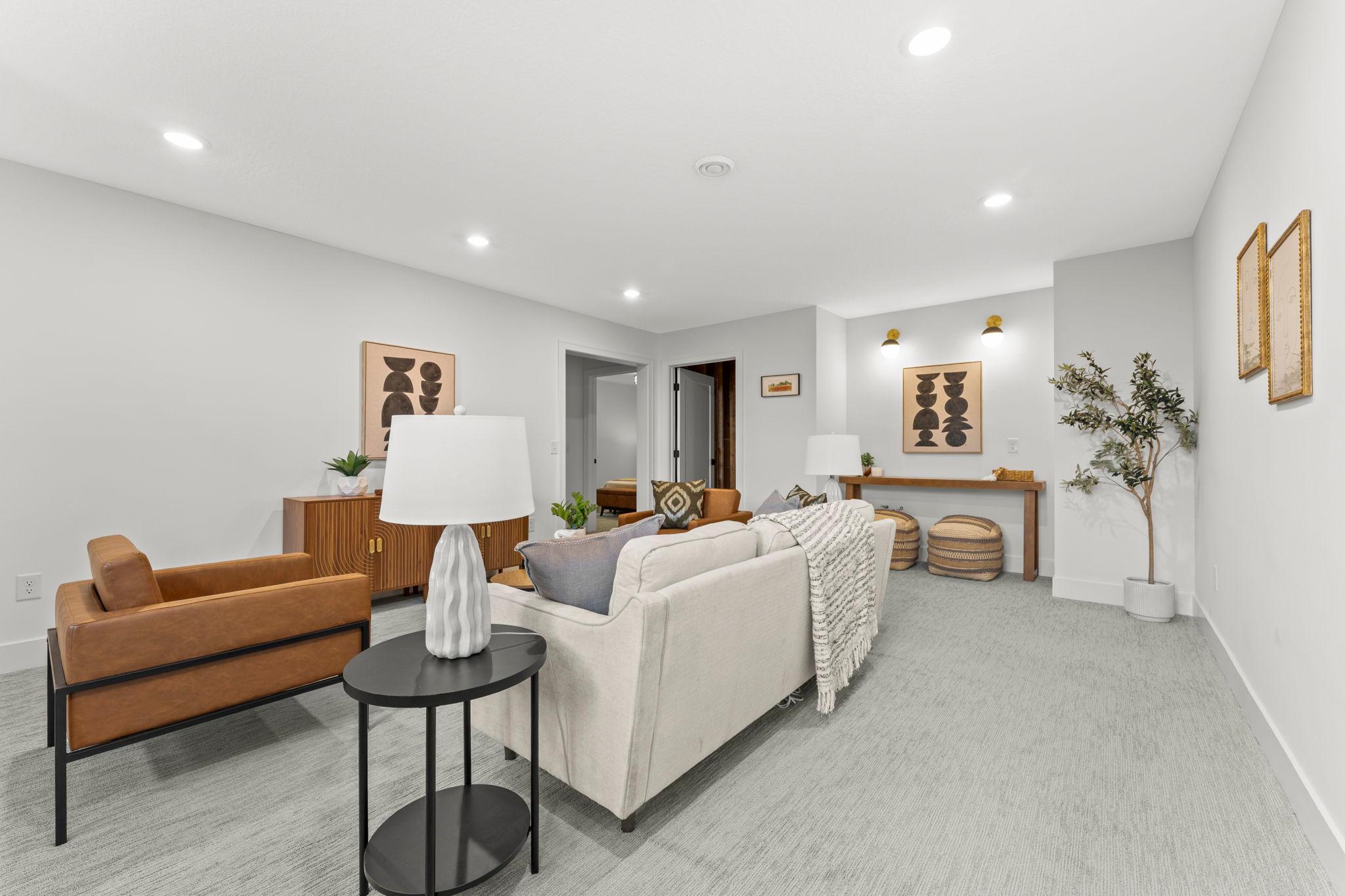 Expansive lower level family room with recessed lighting and plenty of room to gather