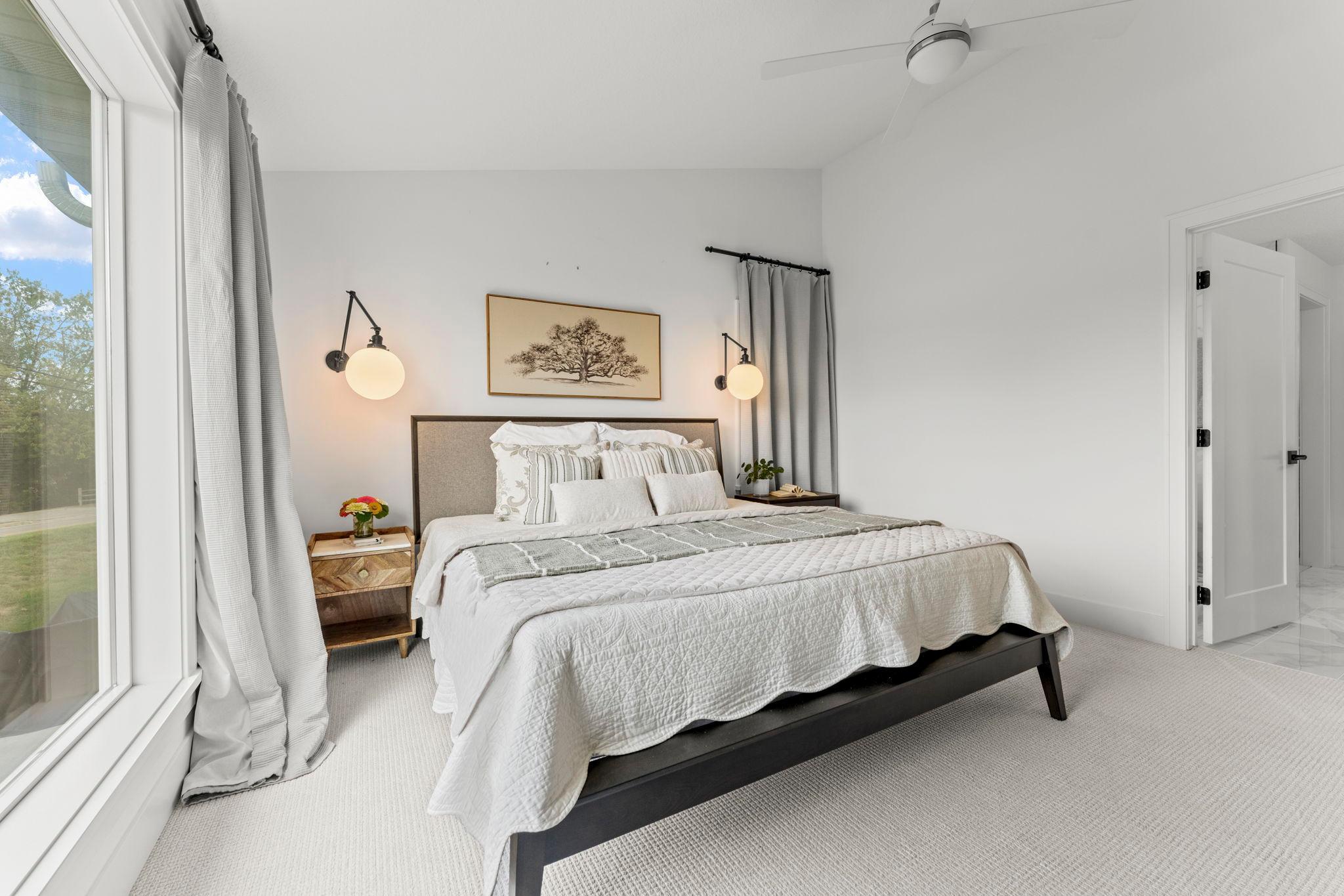 The primary bedroom offers a comfortable retreat with convenient access to the private bathroom